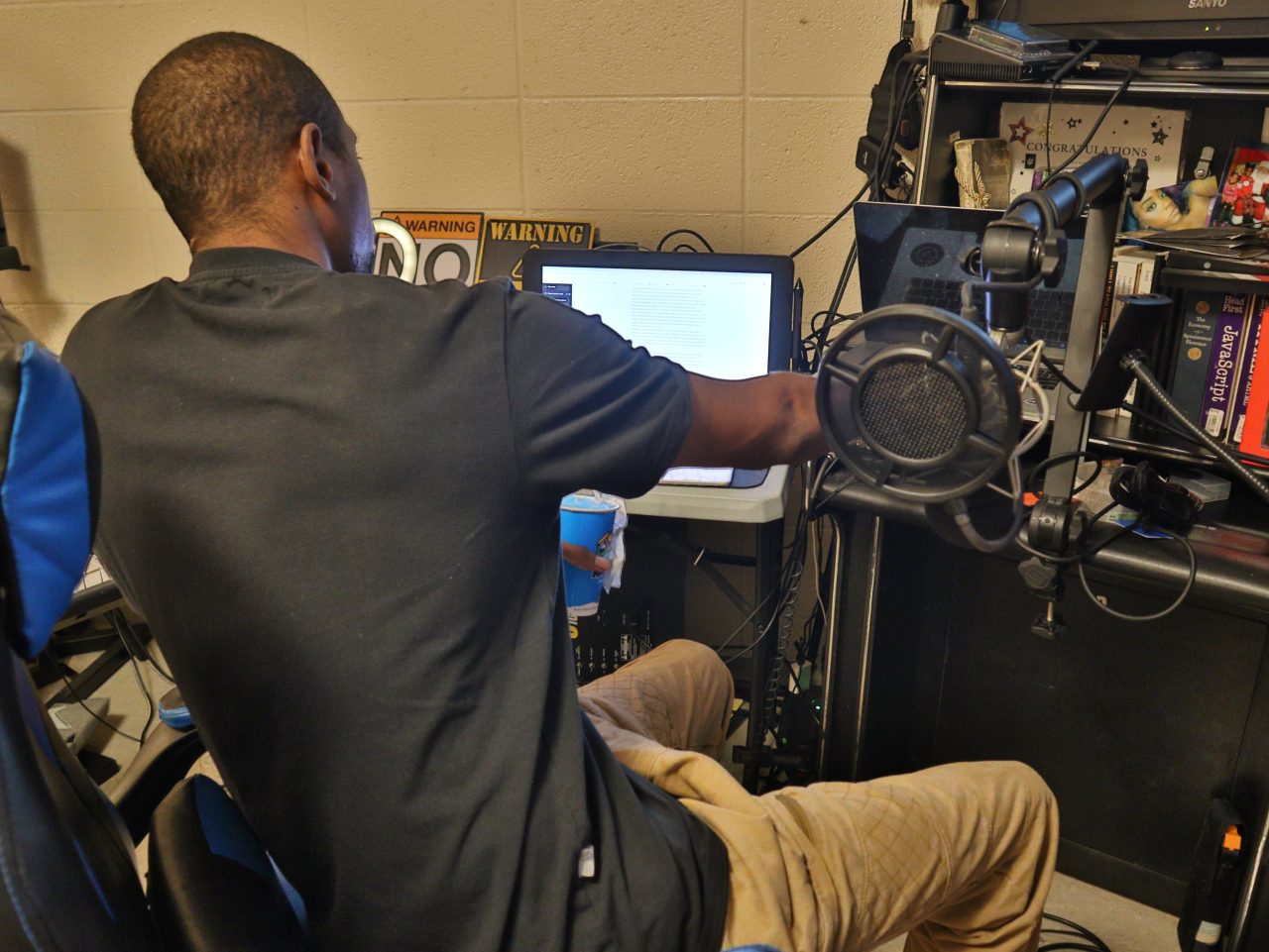 Picture of Truth Trill sitting down in his studio.